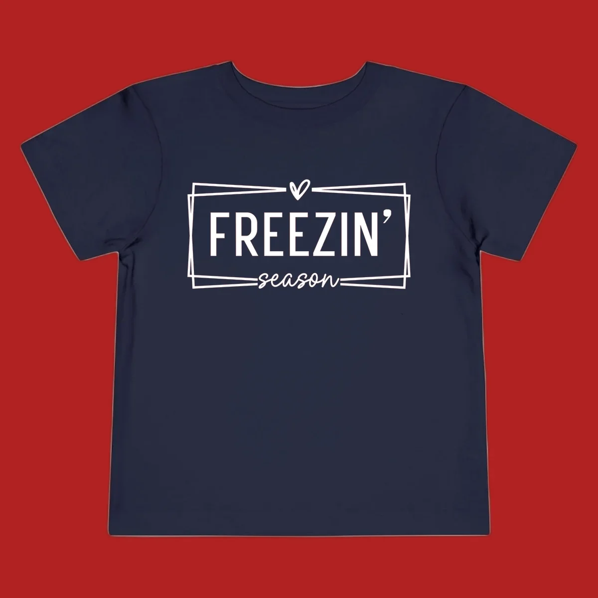 Freezin' Season text design with heart icon and border, for winter holidays.