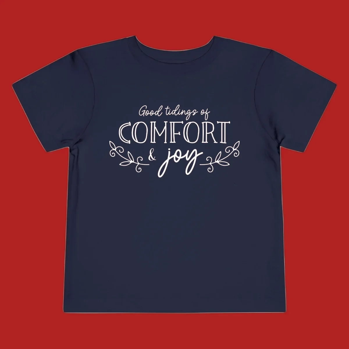 Good tidings of comfort and joy holiday text design with floral accents.