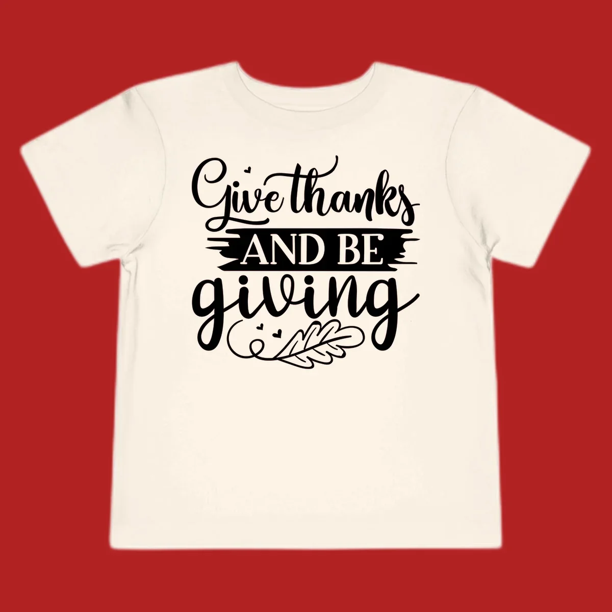 Give thanks and be giving Thanksgiving text with leaf illustration.