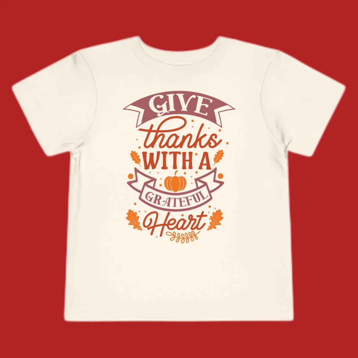 Grateful Heart Thanksgiving design with text, pumpkin, and leaves.