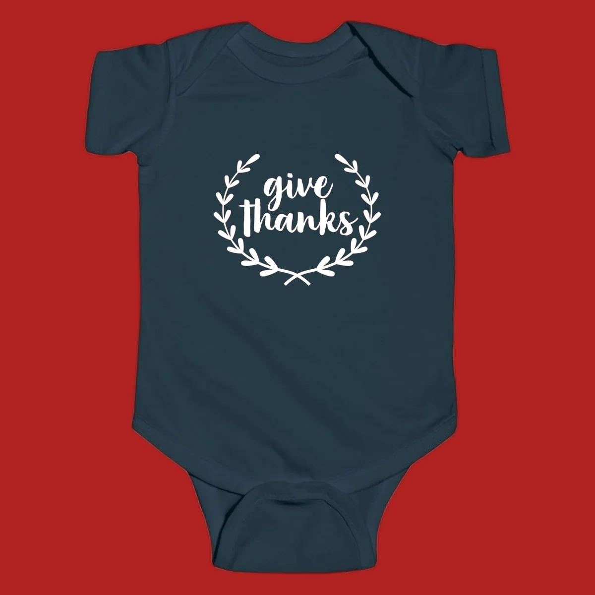 Give thanks script text inside a laurel wreath.
