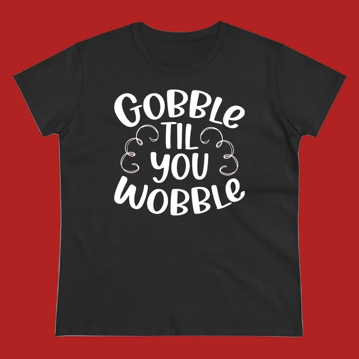 Gobble Til You Wobble Thanksgiving phrase in white text with decorative swirls.