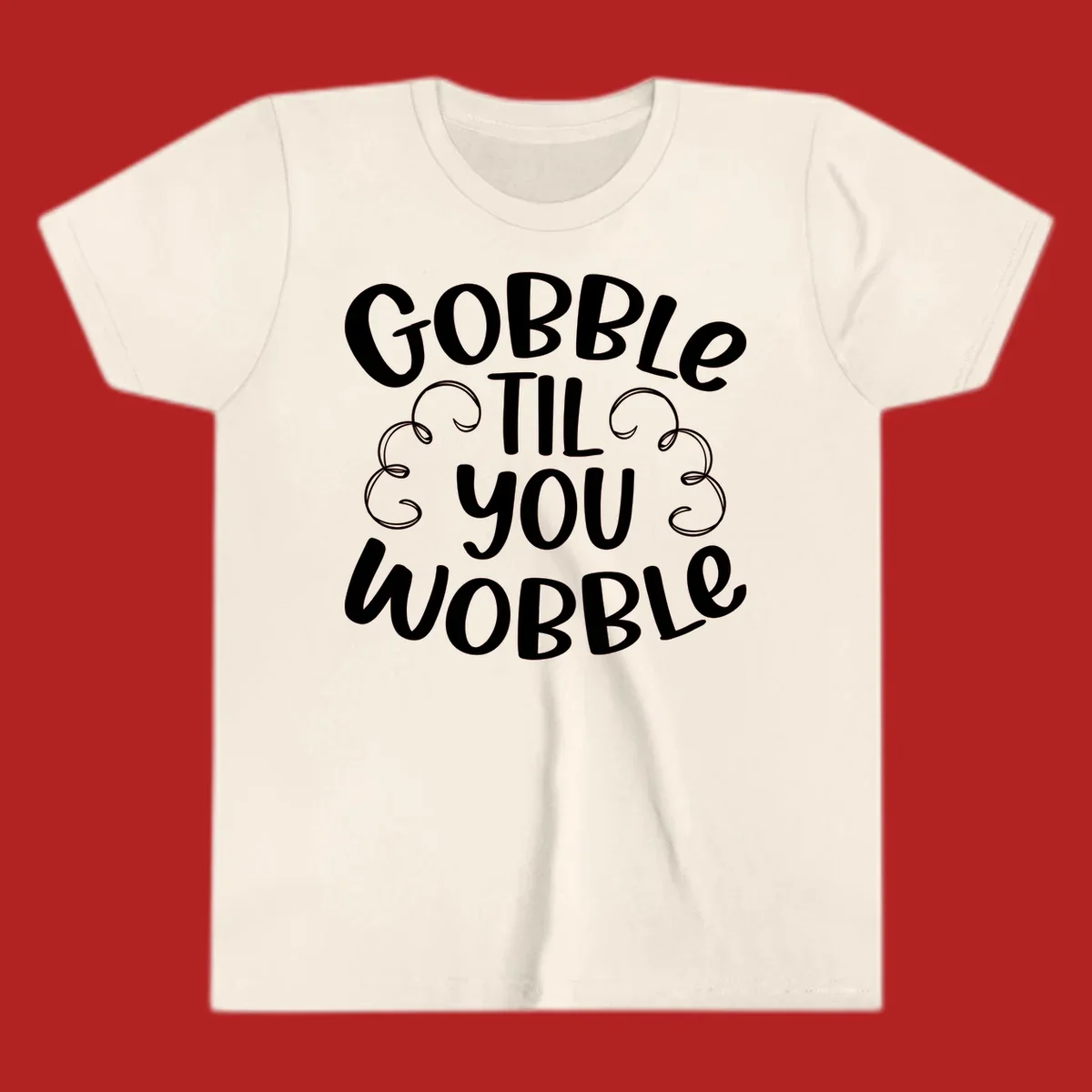 Gobble Til You Wobble Thanksgiving phrase in white text with decorative swirls.