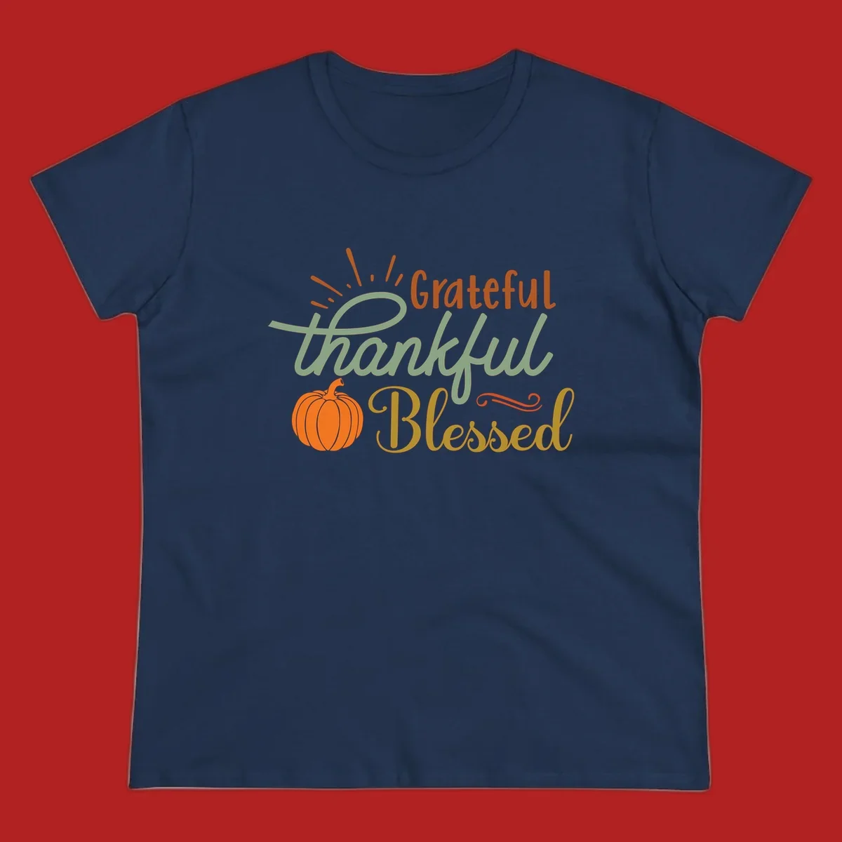 Grateful thankful blessed text with pumpkin and sun rays, autumn holiday design.