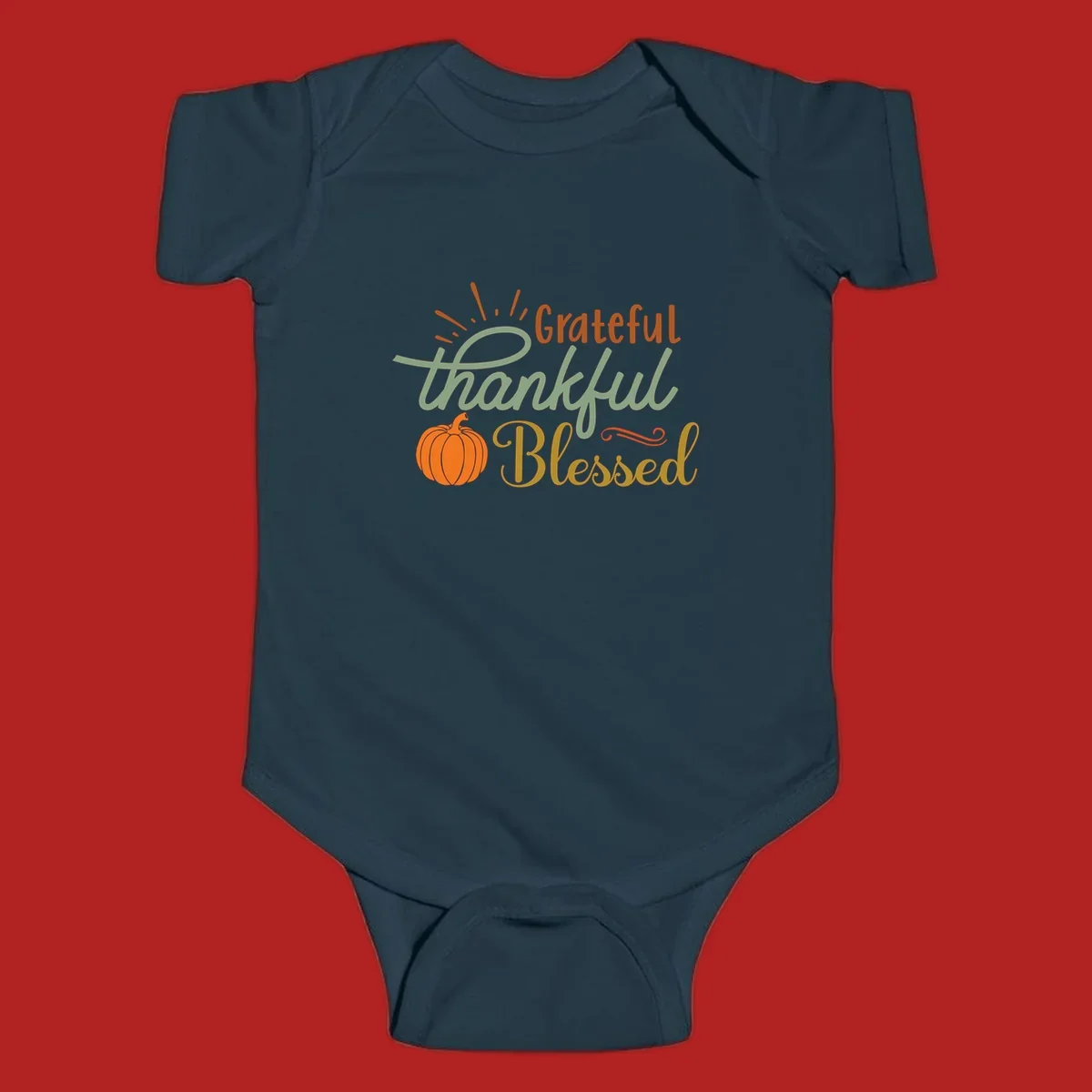 Grateful thankful blessed text with pumpkin and sun rays, autumn holiday design.