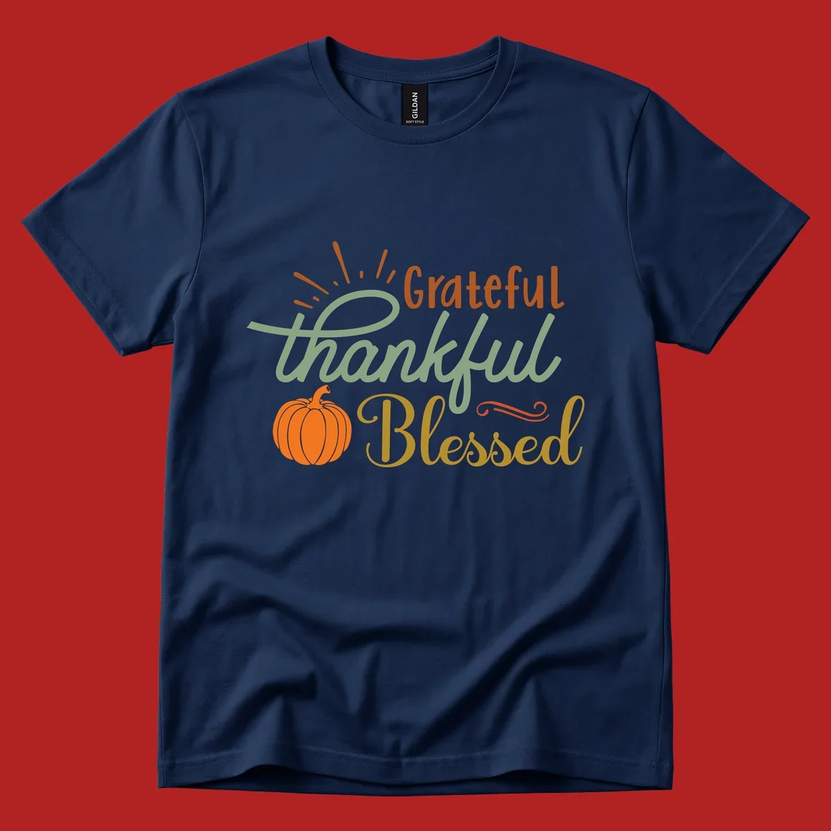 Grateful thankful blessed text with pumpkin and sun rays, autumn holiday design.