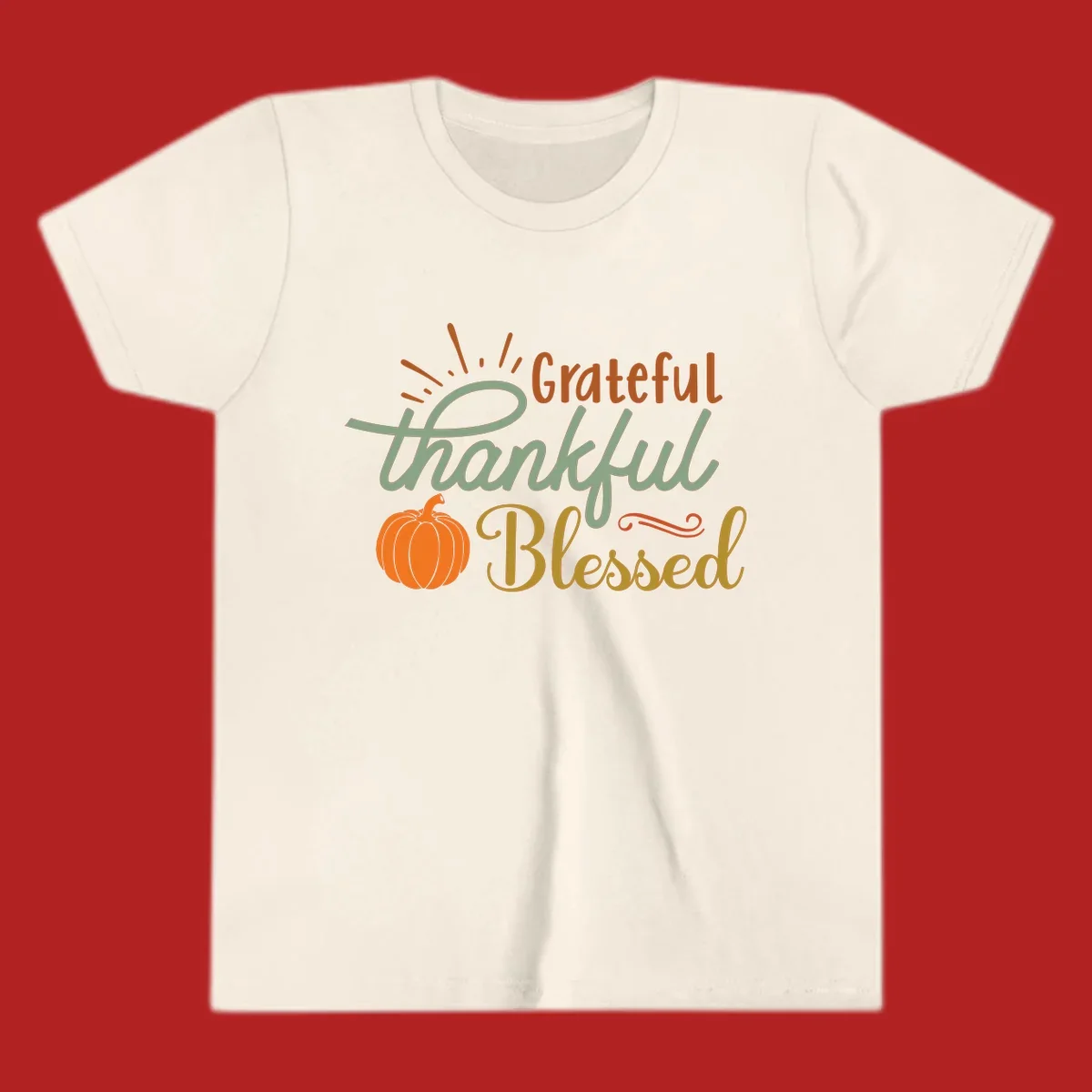Grateful thankful blessed text with pumpkin and sun rays, autumn holiday design.