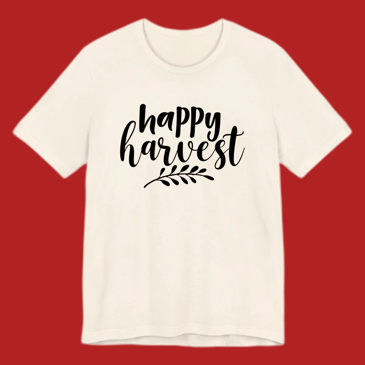 Happy harvest script text with a leaf sprig, suitable for fall and Thanksgiving.