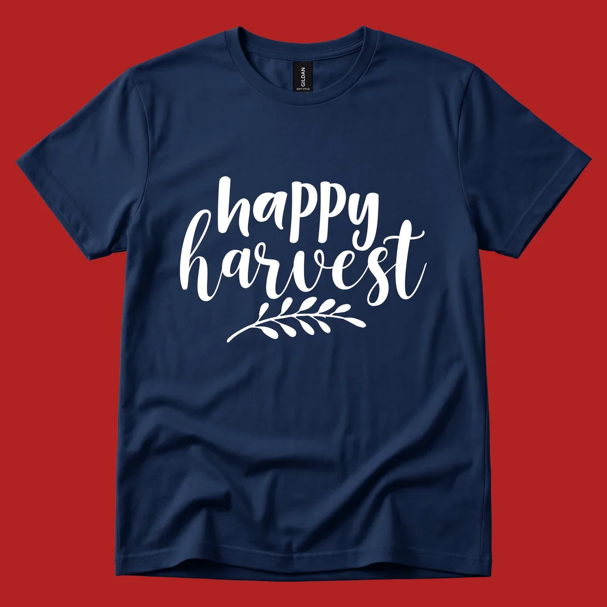Happy harvest script text with a leaf sprig, suitable for fall and Thanksgiving.