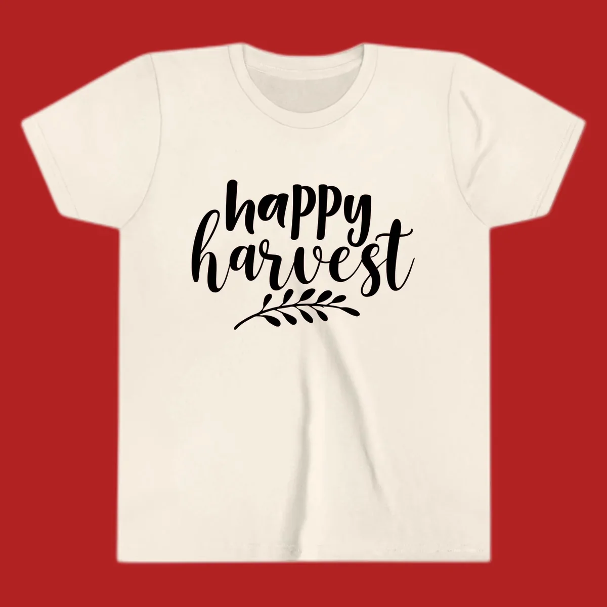 Happy harvest script text with a leaf sprig, suitable for fall and Thanksgiving.