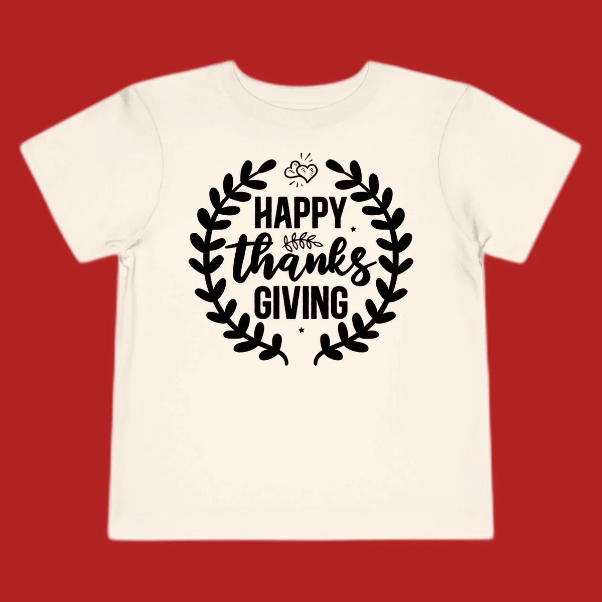 Happy Thanksgiving lettering inside a laurel wreath with hearts and stars.
