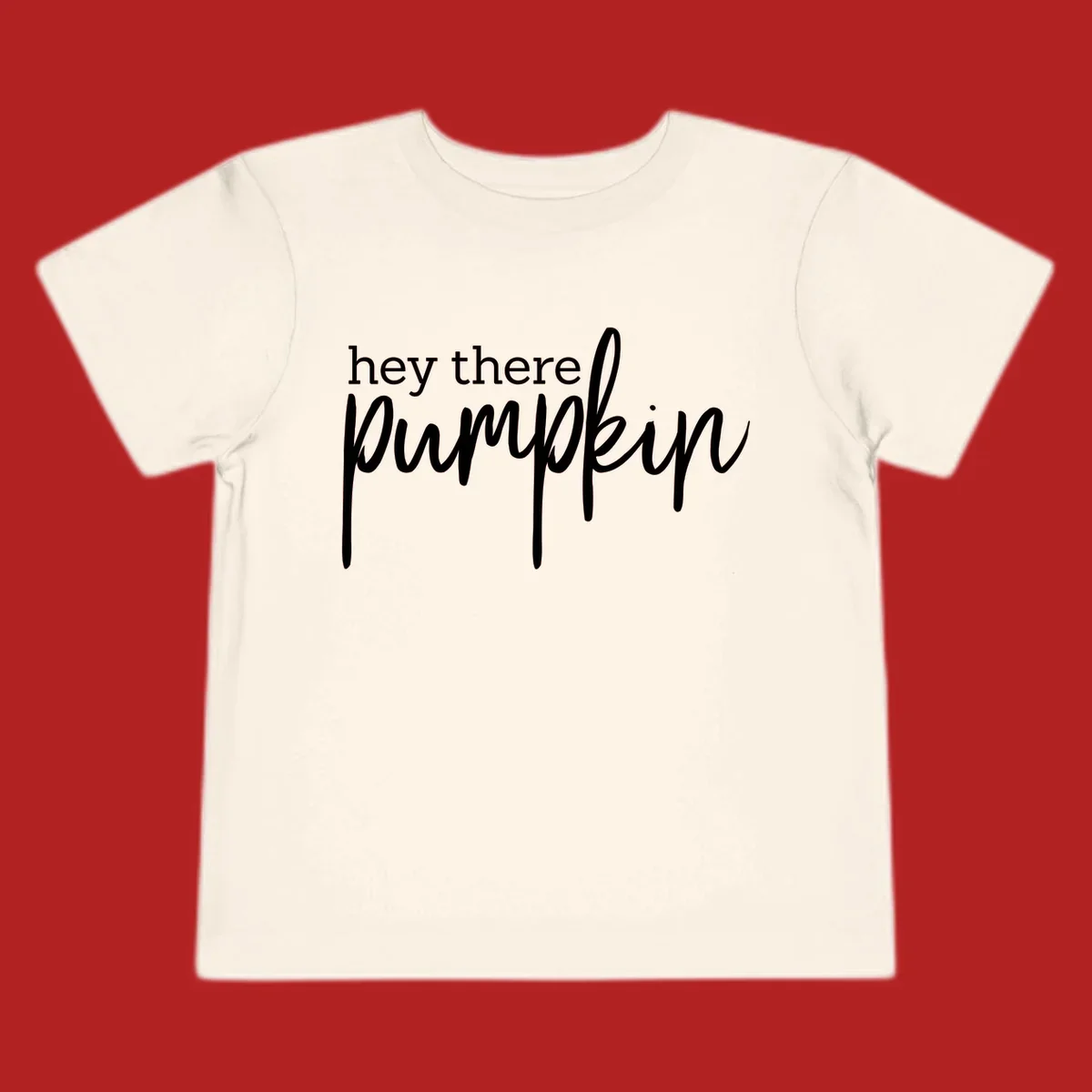 White text design with "hey there" in block font and "pumpkin" in script font, on a black background.