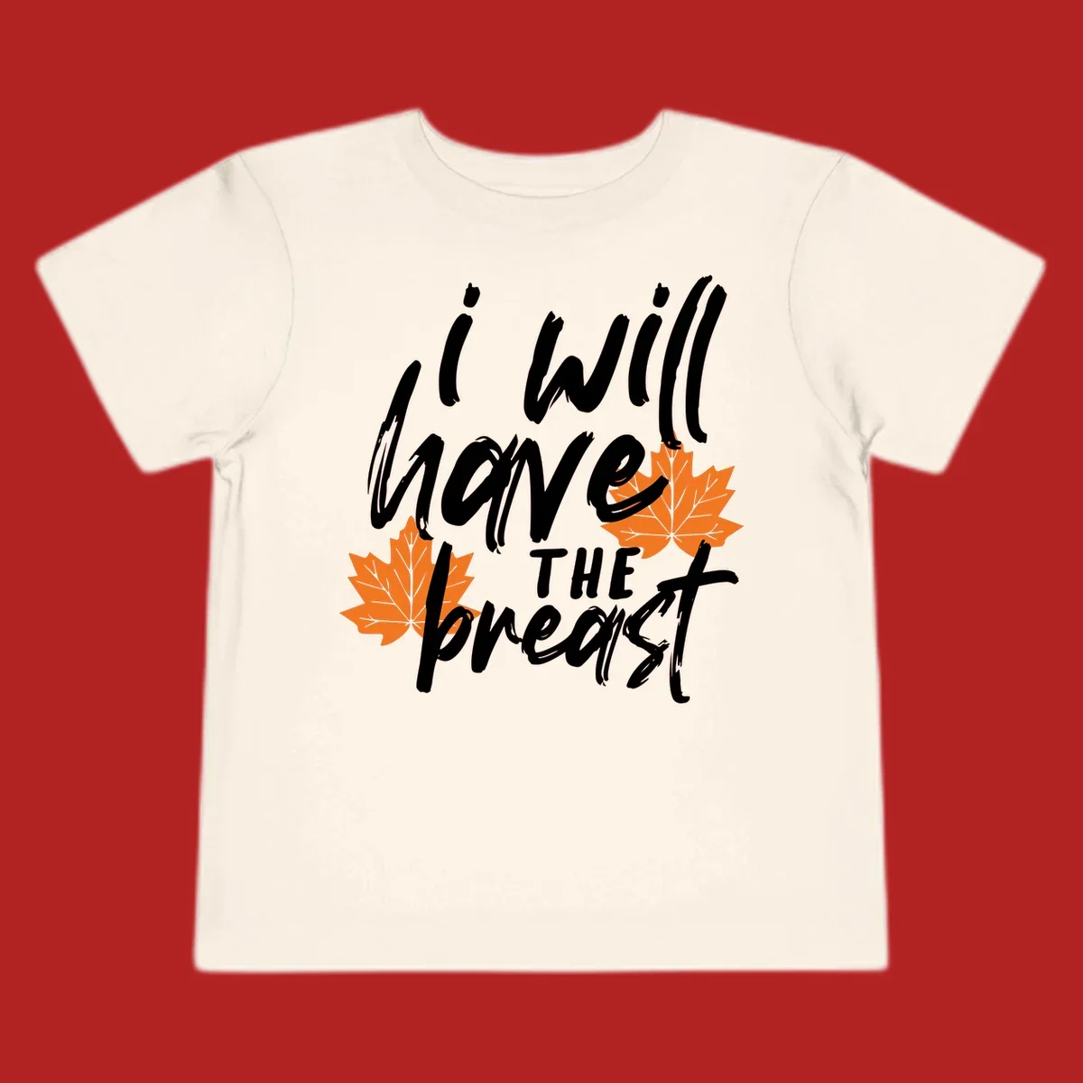 Thanksgiving pun design with text "i will have THE breast" and orange maple leaves.