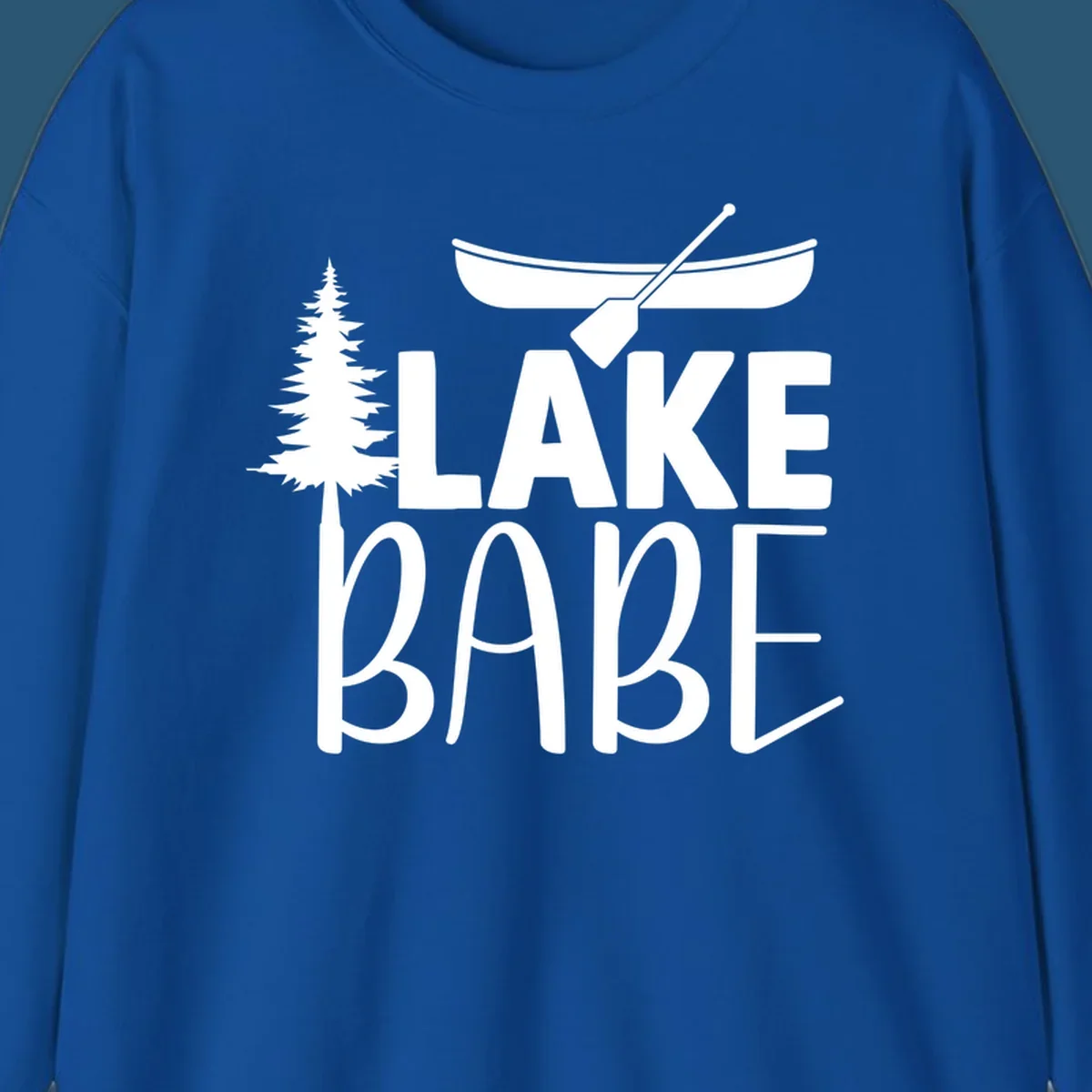 Lake Babe design with canoe, pine tree, and text. Lake-babe-style graphic.