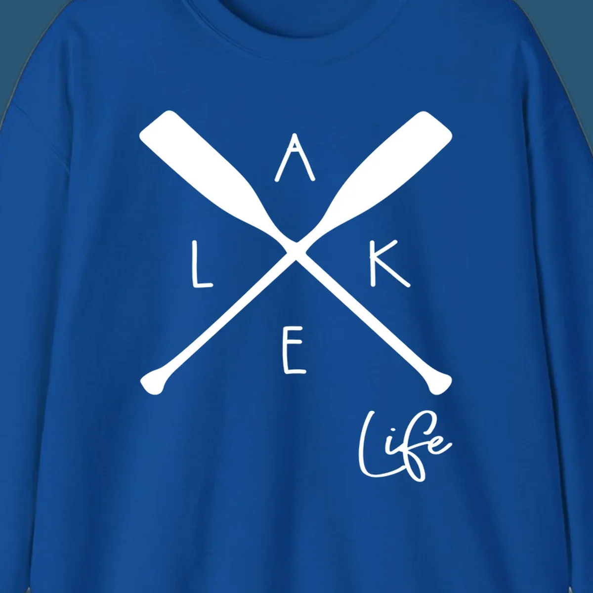 Lake life design with crossed oars and text.