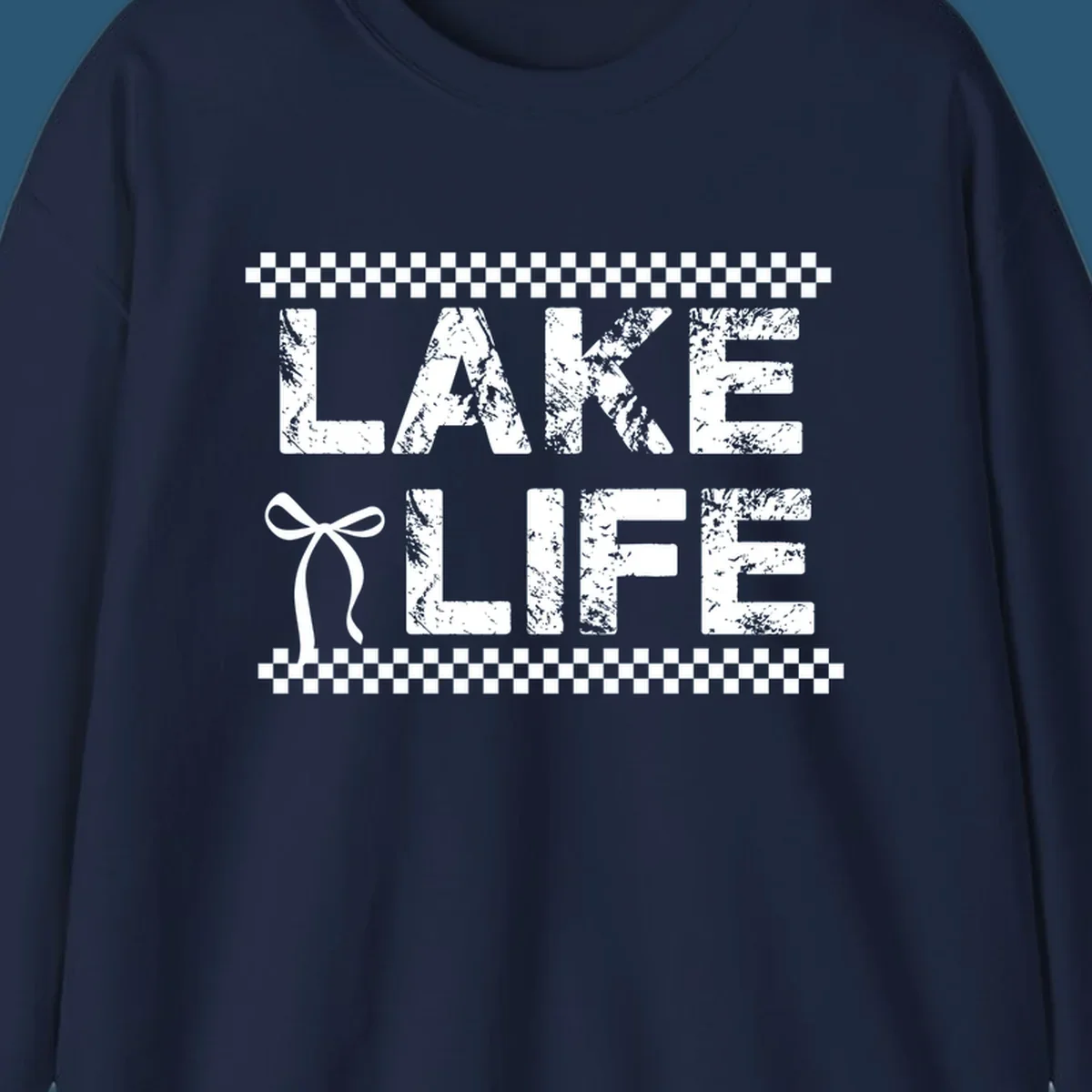 Lake Life text with bow accent and checkerboard border, distressed font.