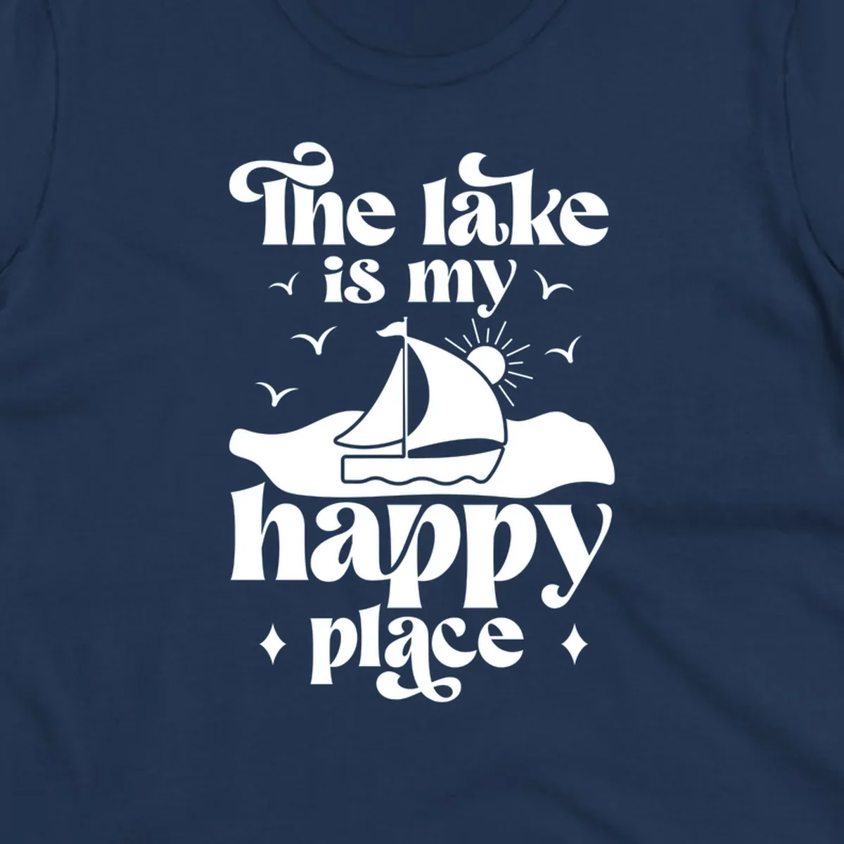 Retro text design 'The lake is my happy place' with sailboat, sun, and birds.