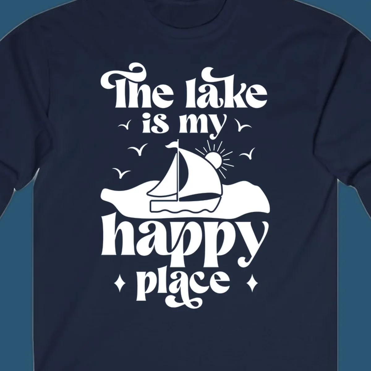 Retro text design 'The lake is my happy place' with sailboat, sun, and birds.