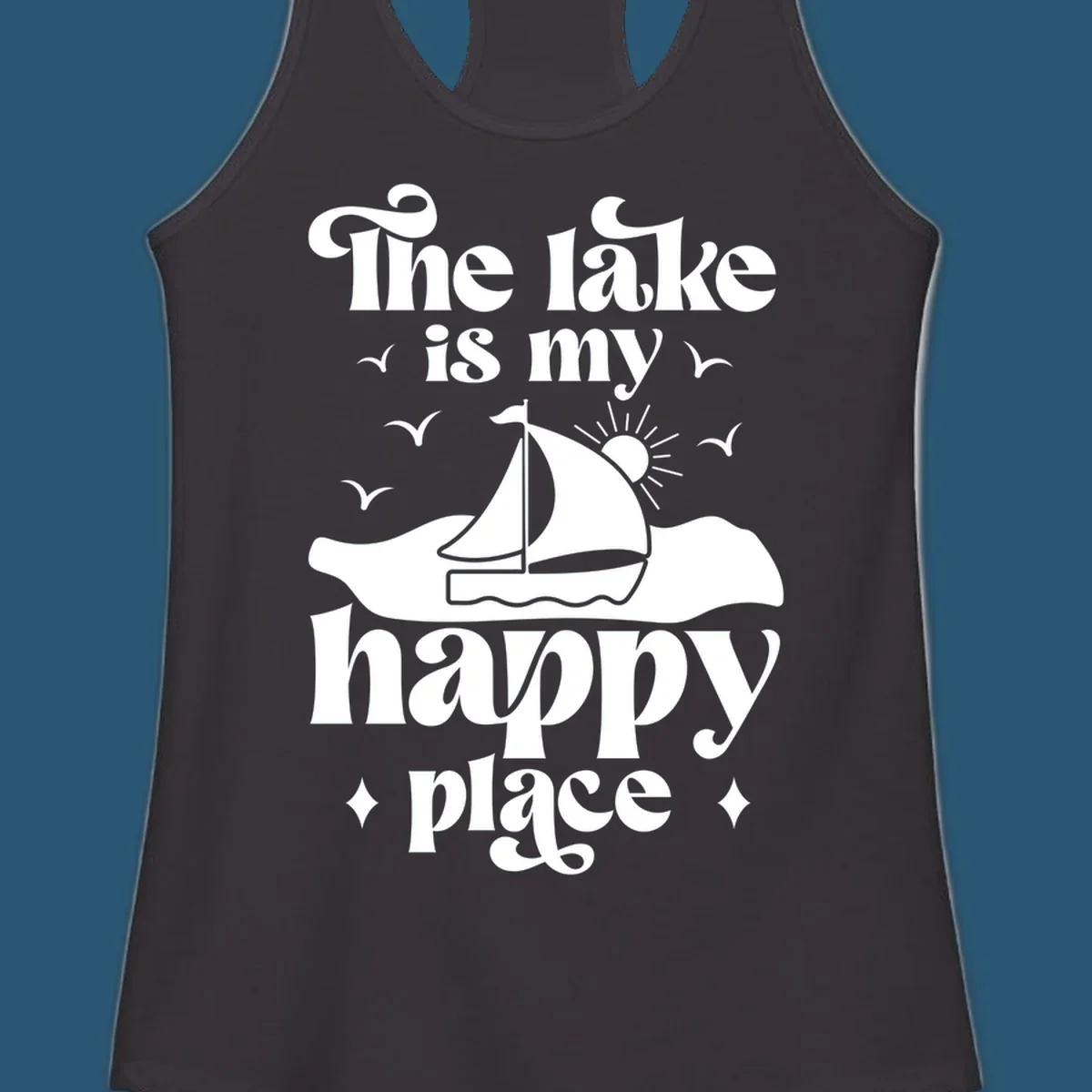 Retro text design 'The lake is my happy place' with sailboat, sun, and birds.
