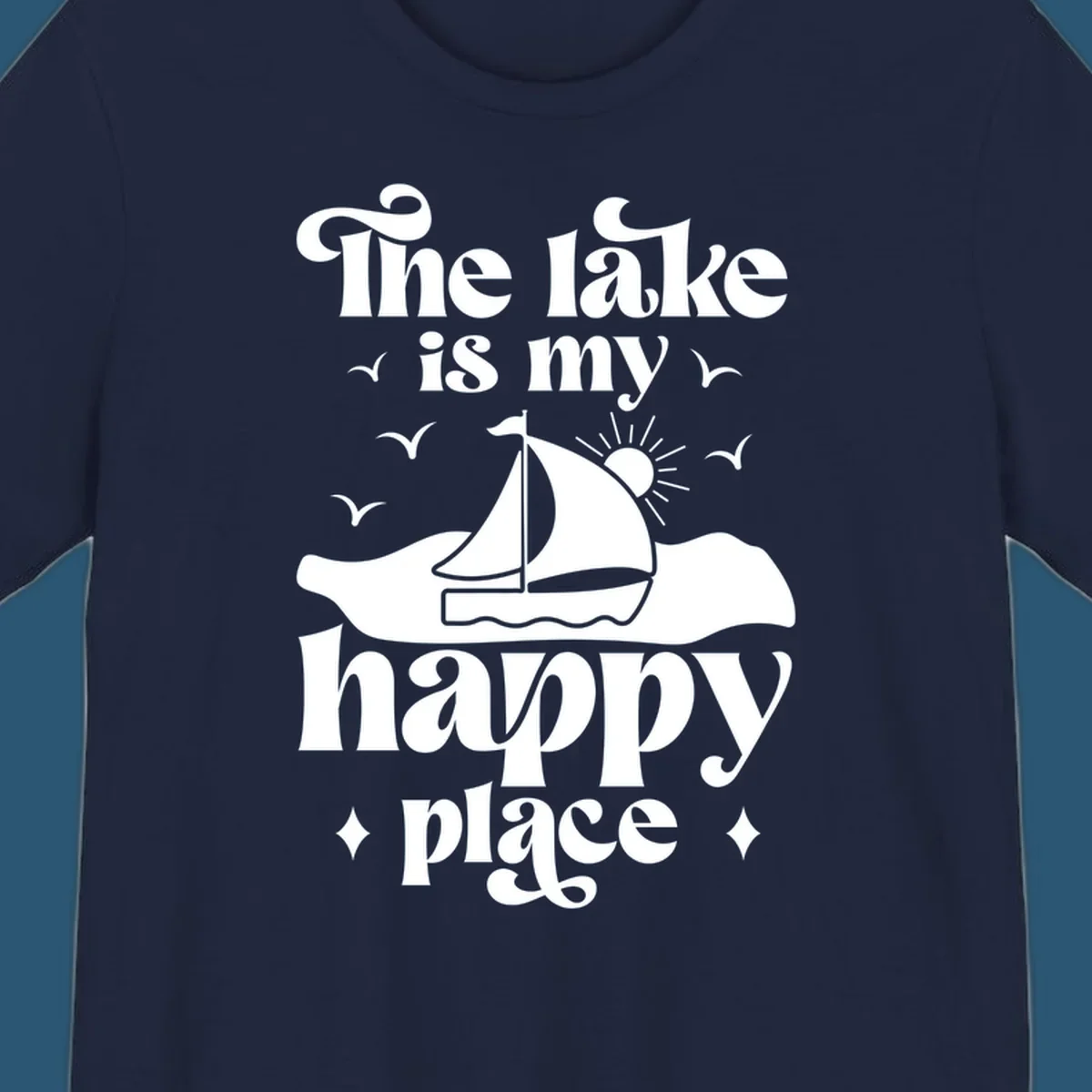 Retro text design 'The lake is my happy place' with sailboat, sun, and birds.