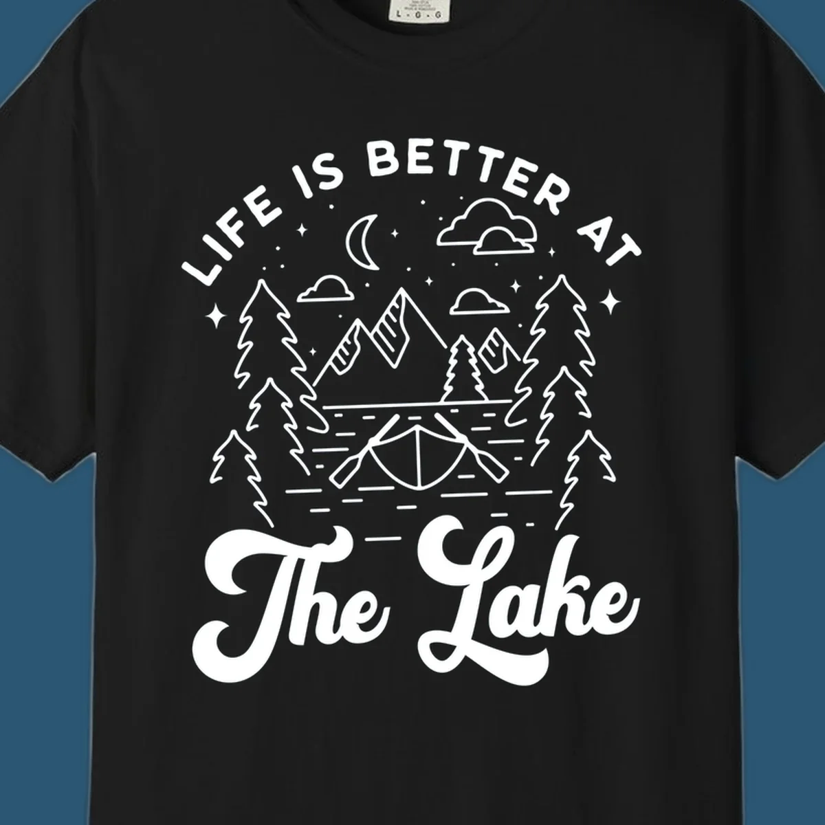 Lake life graphic with mountains, canoe, moon, and text 'Life Is Better At The Lake'.