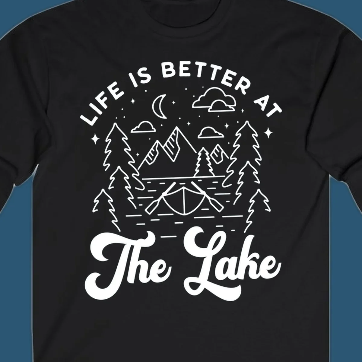 Lake life graphic with mountains, canoe, moon, and text 'Life Is Better At The Lake'.