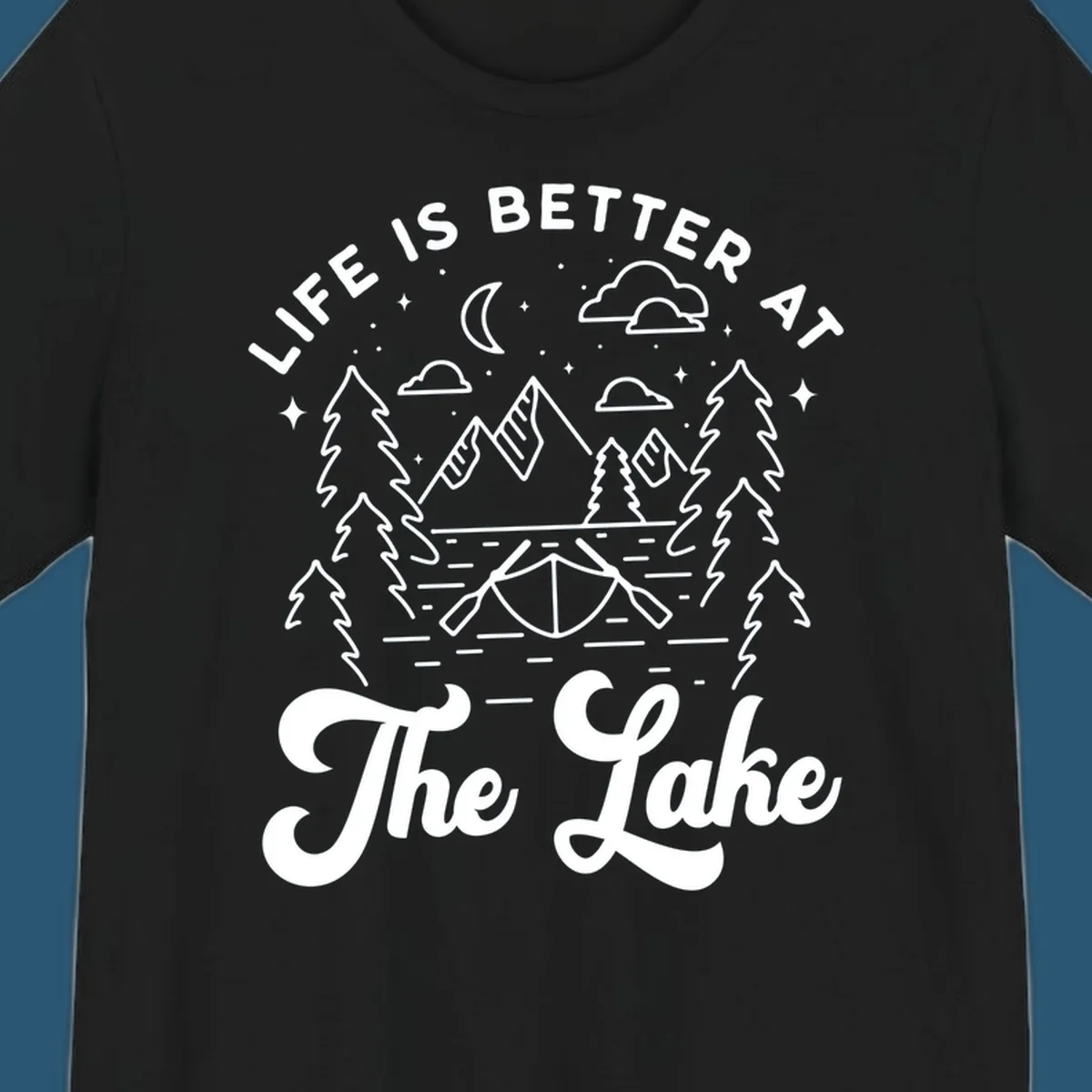 Lake life graphic with mountains, canoe, moon, and text 'Life Is Better At The Lake'.