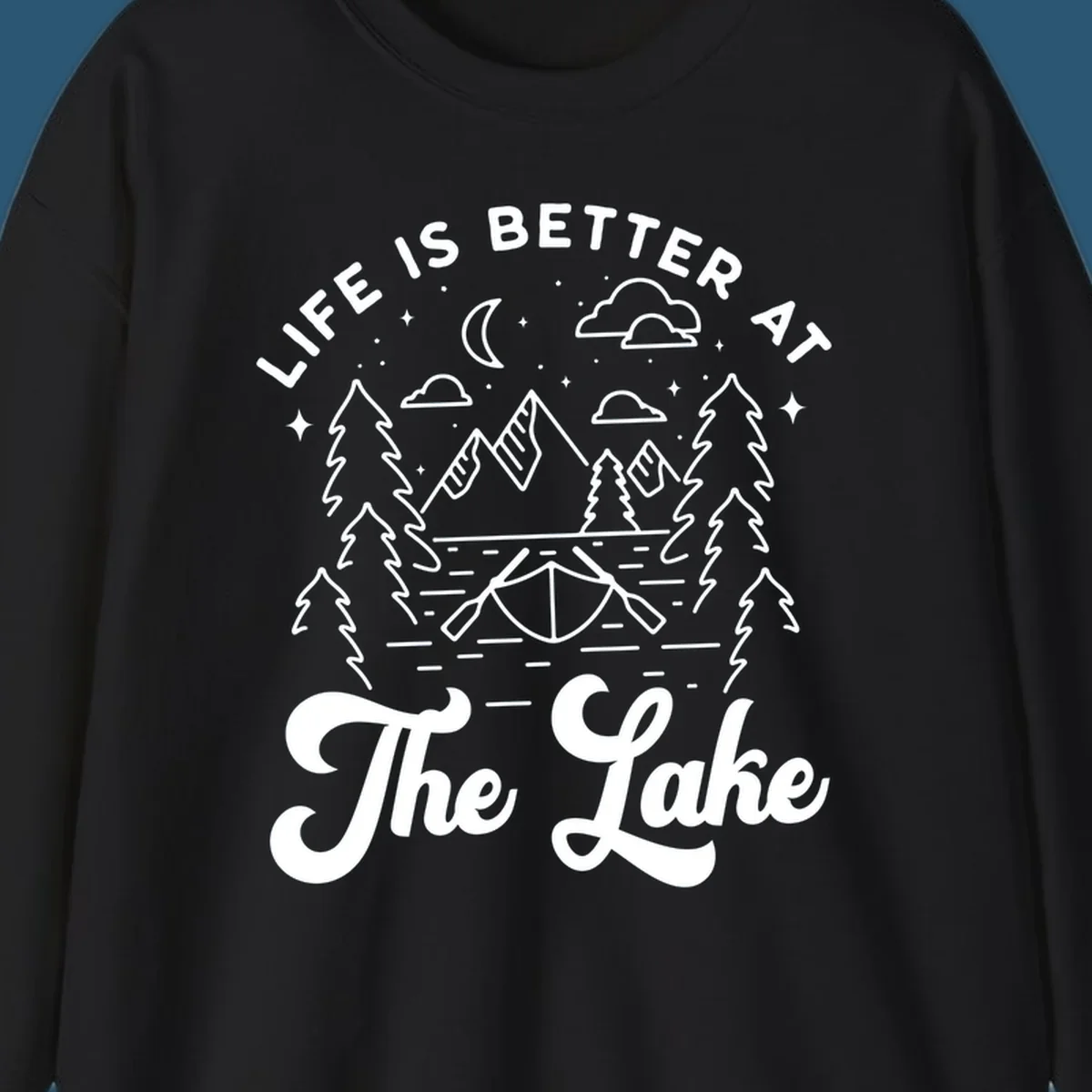 Lake life graphic with mountains, canoe, moon, and text 'Life Is Better At The Lake'.