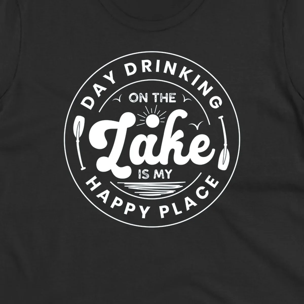Circular badge design with text 'Day Drinking On The Lake Is My Happy Place' and lake-themed graphics.