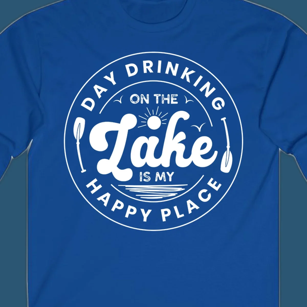 Circular badge design with text 'Day Drinking On The Lake Is My Happy Place' and lake-themed graphics.