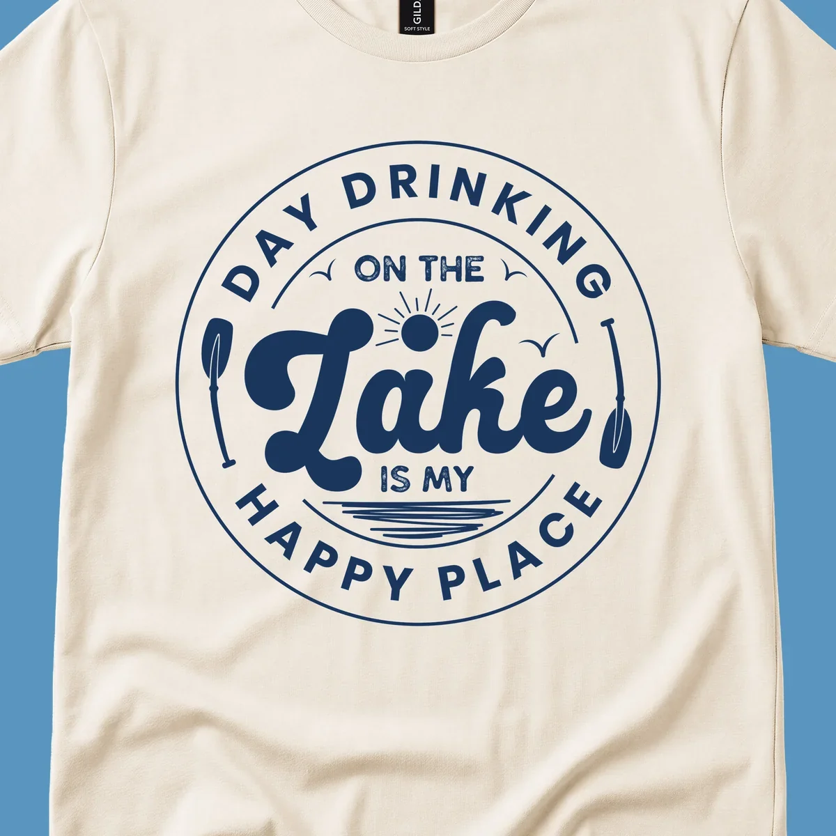 Circular badge design with text 'Day Drinking On The Lake Is My Happy Place' and lake-themed graphics.