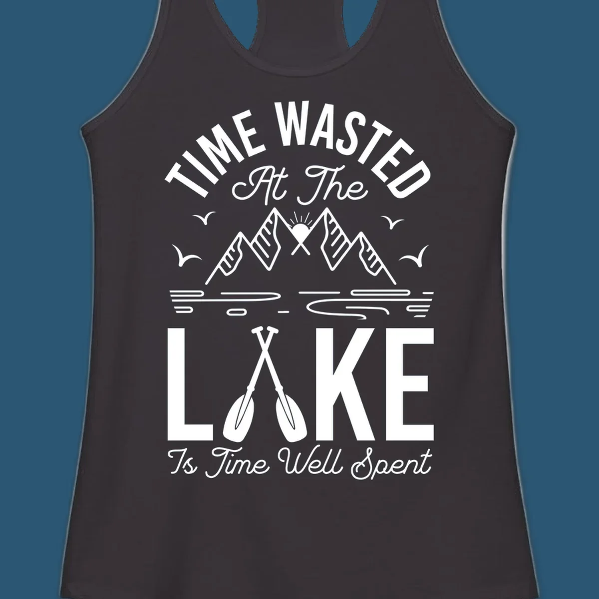 Illustration of mountains, sun, birds, and oars with text 'Time Wasted At The Lake Is Time Well Spent'.