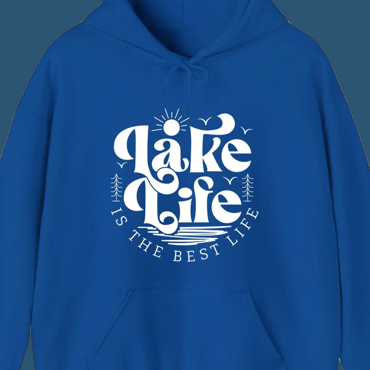 Lake life is the best life typography design with sun, birds, trees, and water elements.