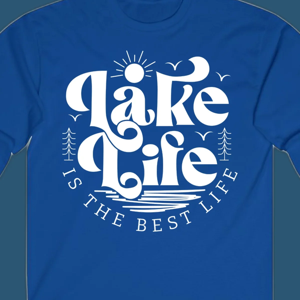 Lake life is the best life typography design with sun, birds, trees, and water elements.