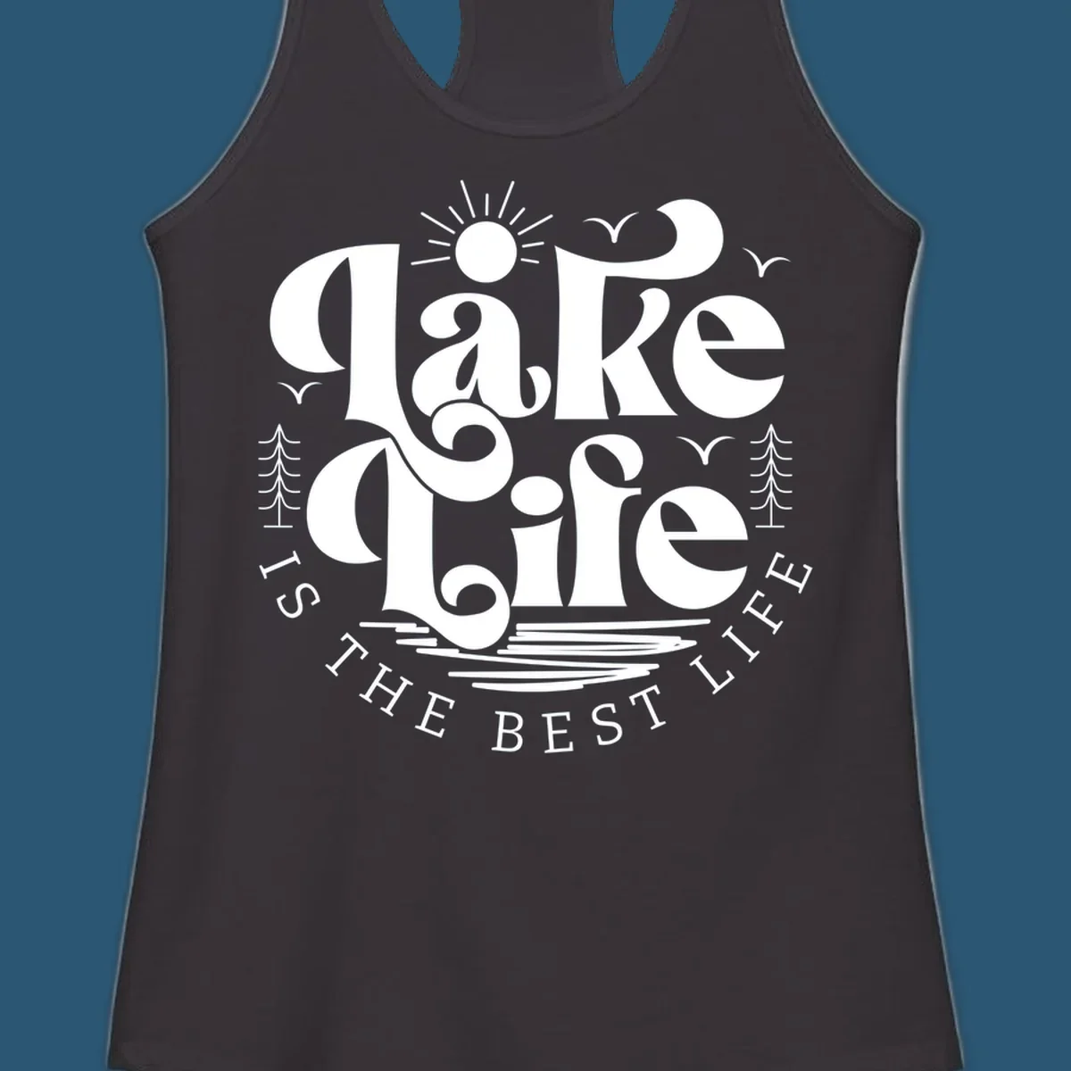 Lake life is the best life typography design with sun, birds, trees, and water elements.