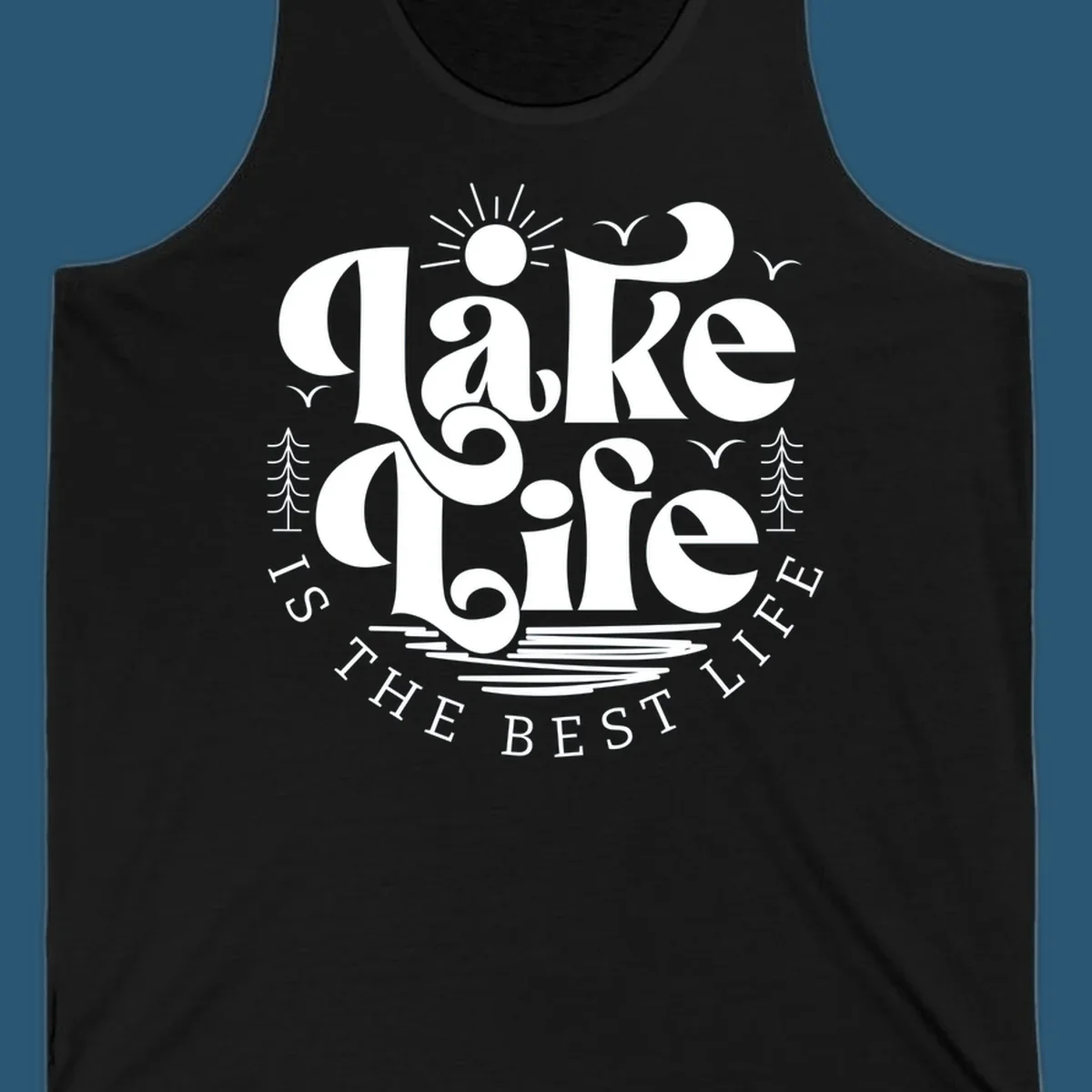 Lake life is the best life typography design with sun, birds, trees, and water elements.