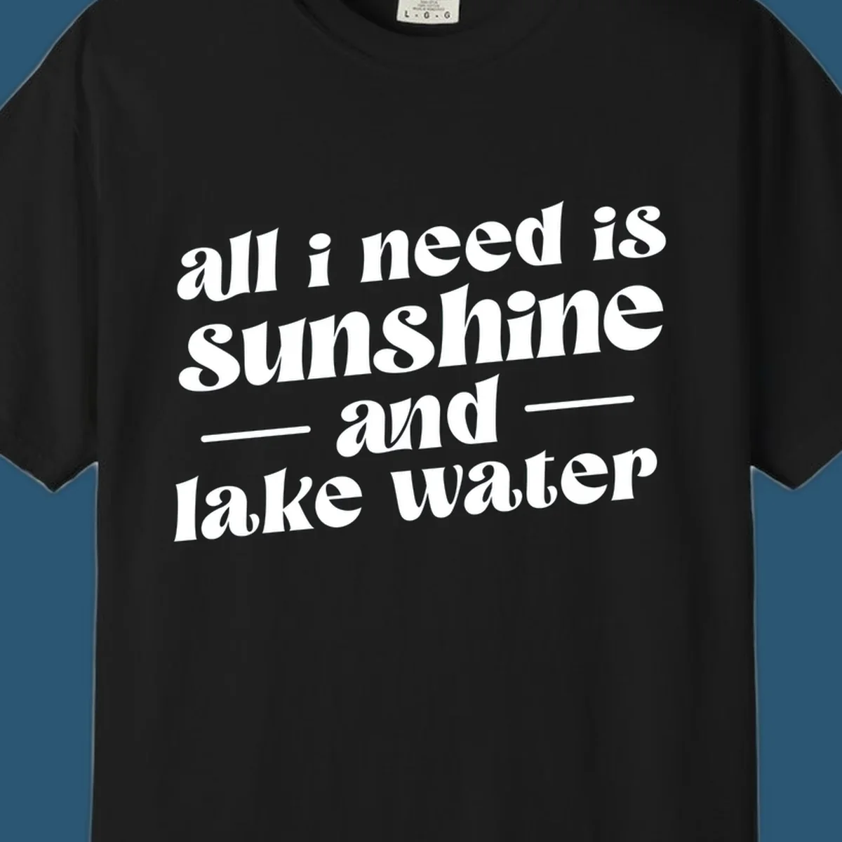 Text design 'all i need is sunshine and lake water' in a retro font, perfect for lake days.