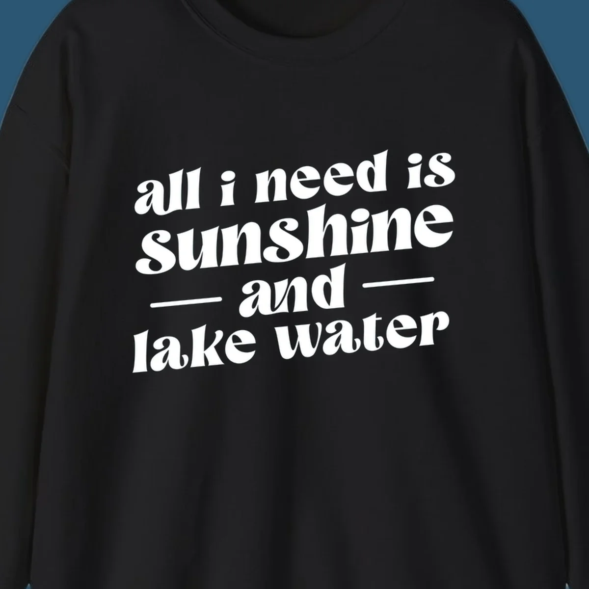 Text design 'all i need is sunshine and lake water' in a retro font, perfect for lake days.