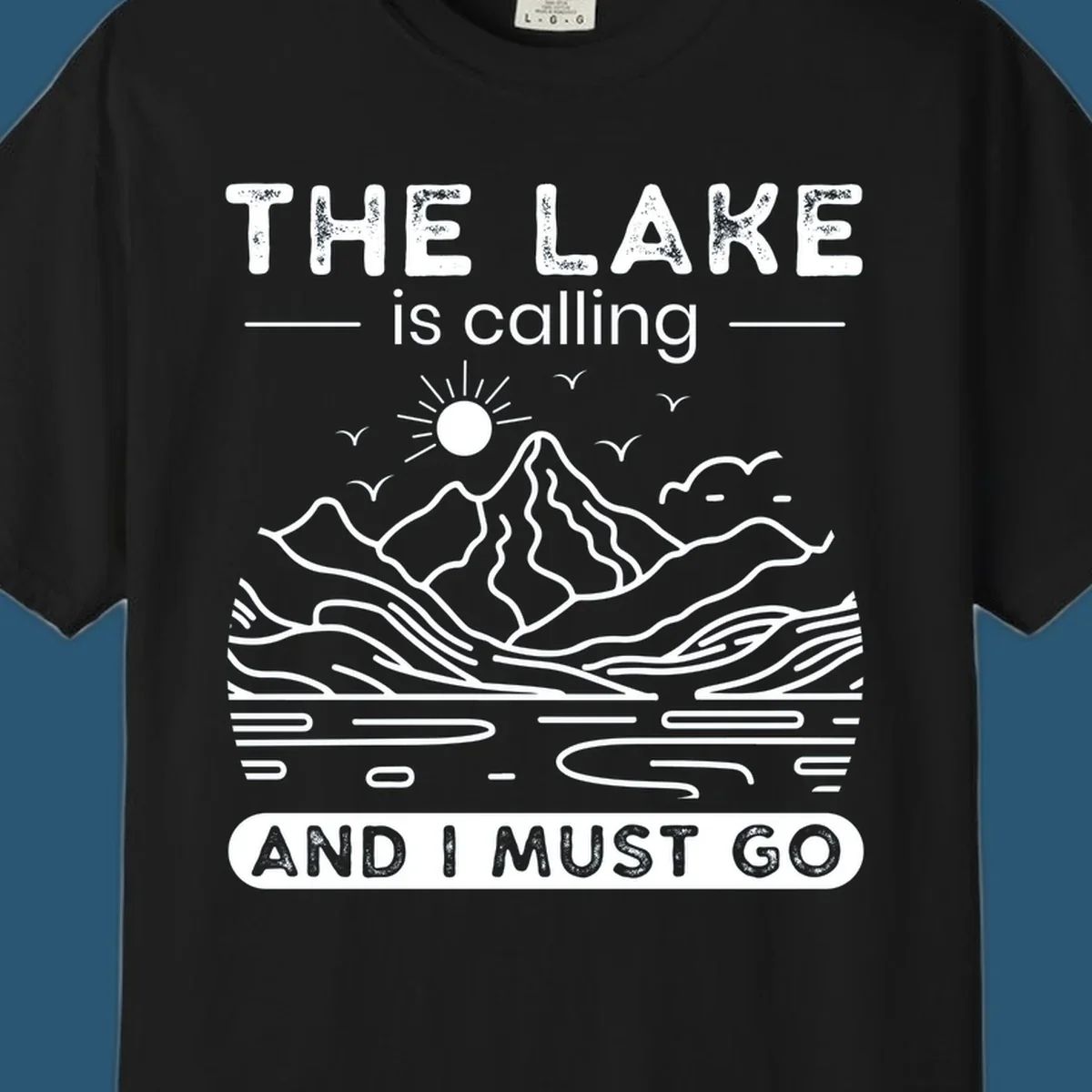 The Lake is Calling And I Must Go scenic nature design with mountains and lake.