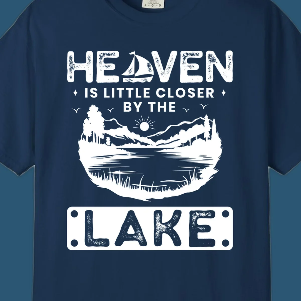 Heaven Is Little Closer By The Lake scenic design with lake, mountains, and sailboat.