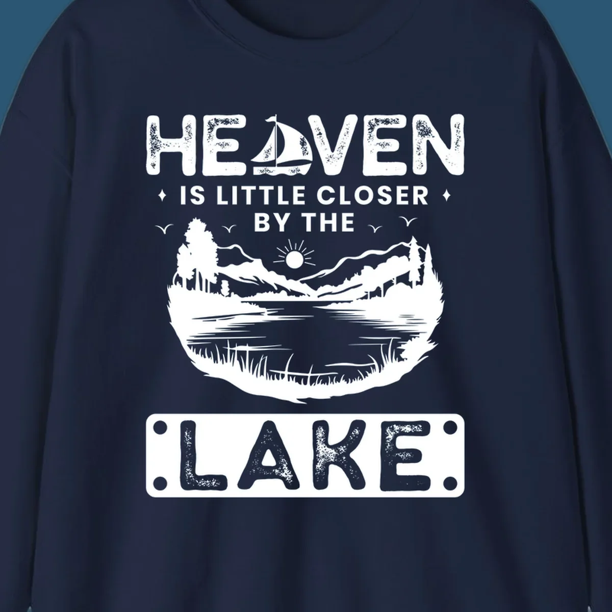Heaven Is Little Closer By The Lake scenic design with lake, mountains, and sailboat.