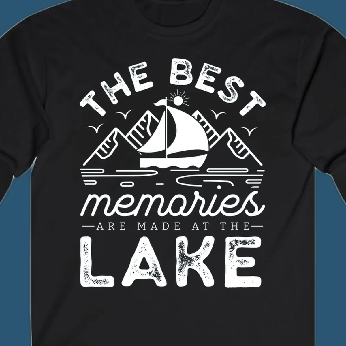 The Best Memories Are Made At The Lake design with mountains, sailboat, and text.