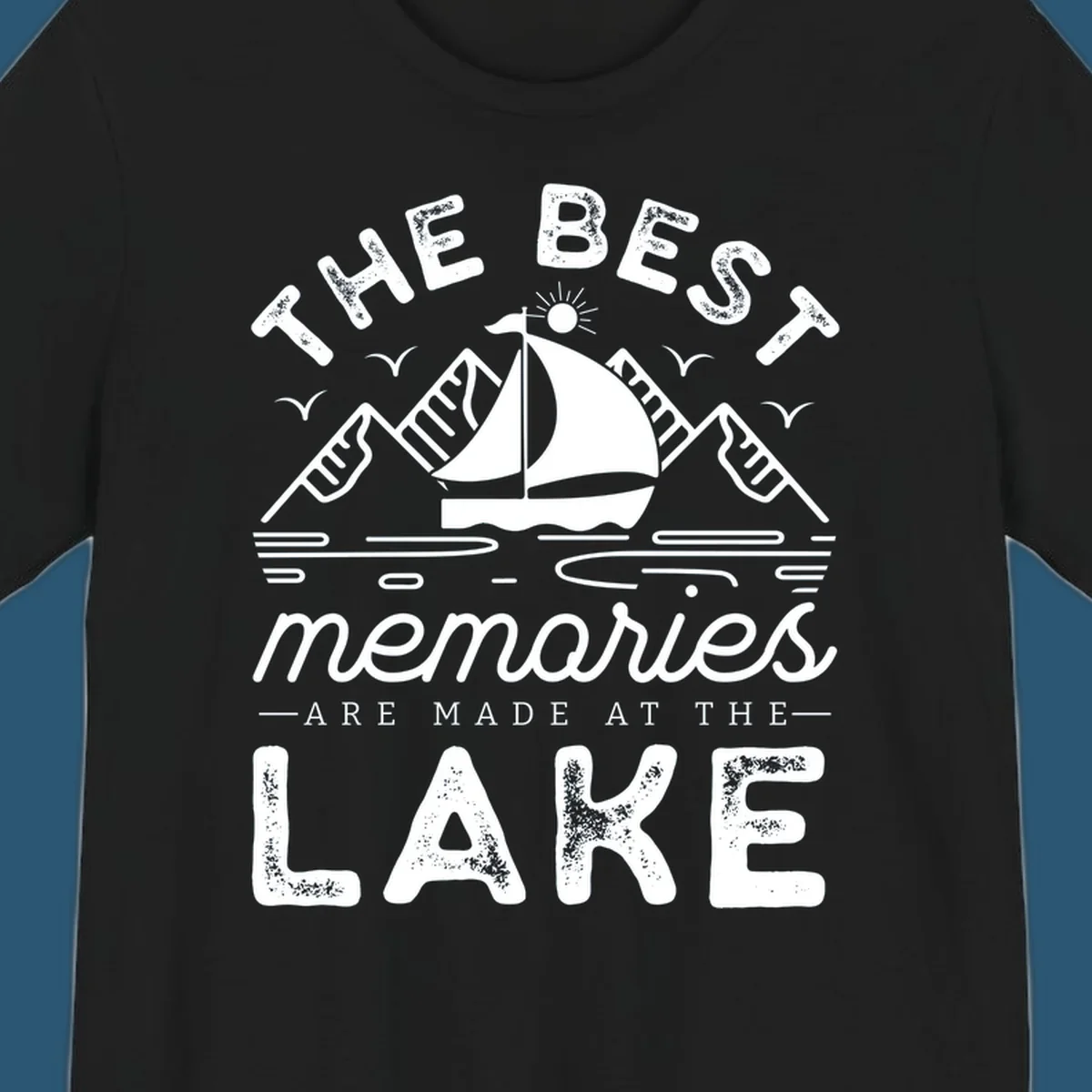 The Best Memories Are Made At The Lake design with mountains, sailboat, and text.