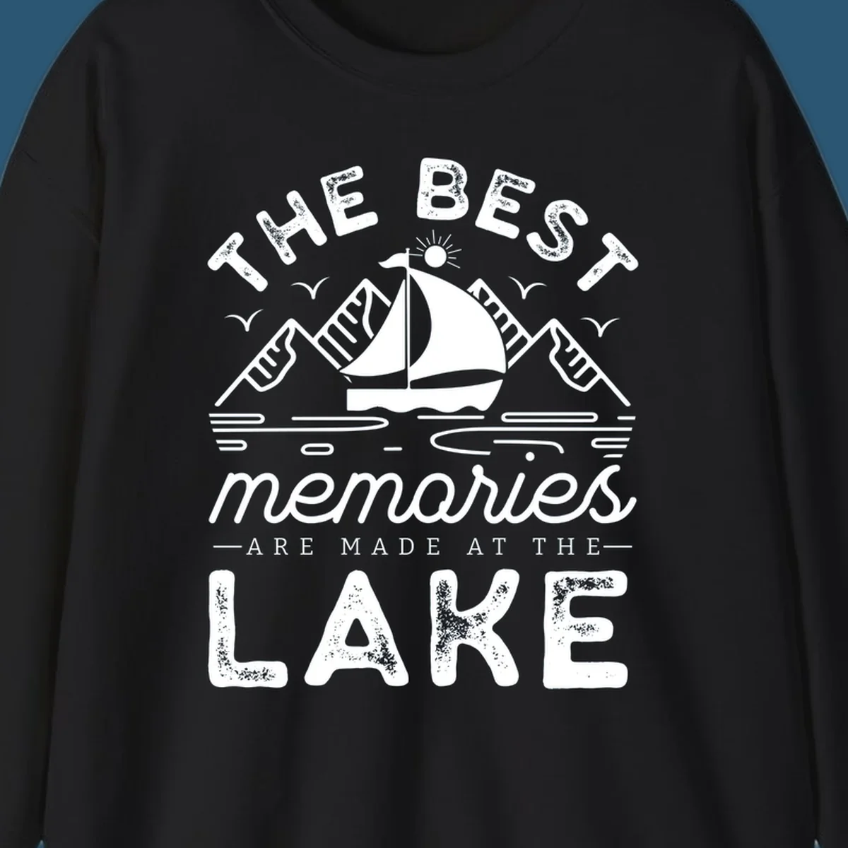 The Best Memories Are Made At The Lake design with mountains, sailboat, and text.