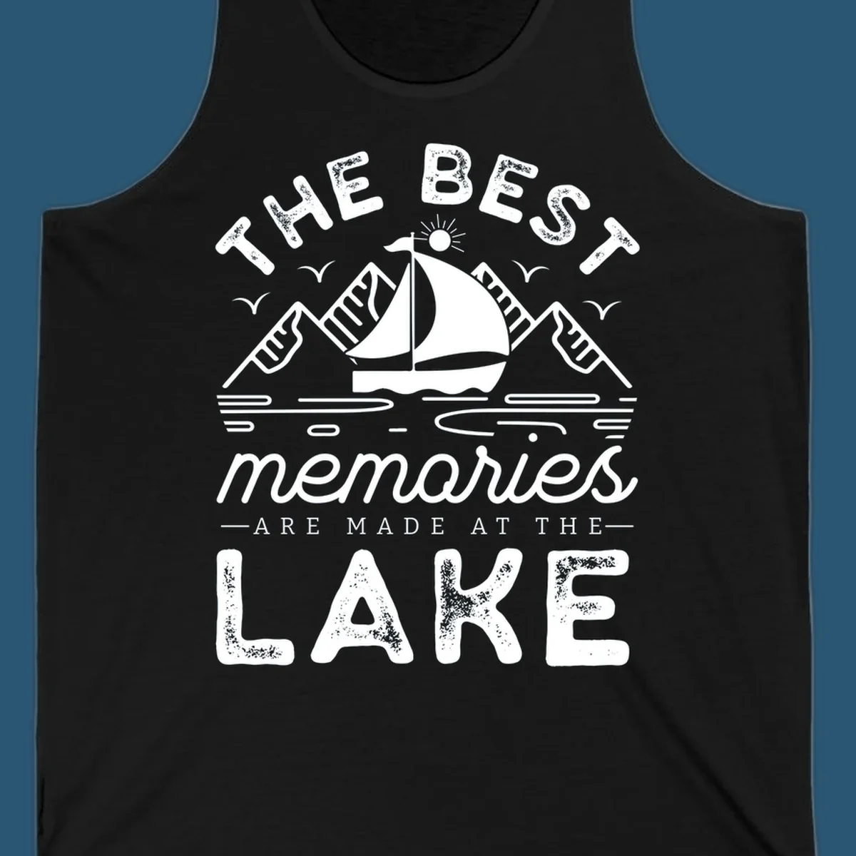 The Best Memories Are Made At The Lake design with mountains, sailboat, and text.