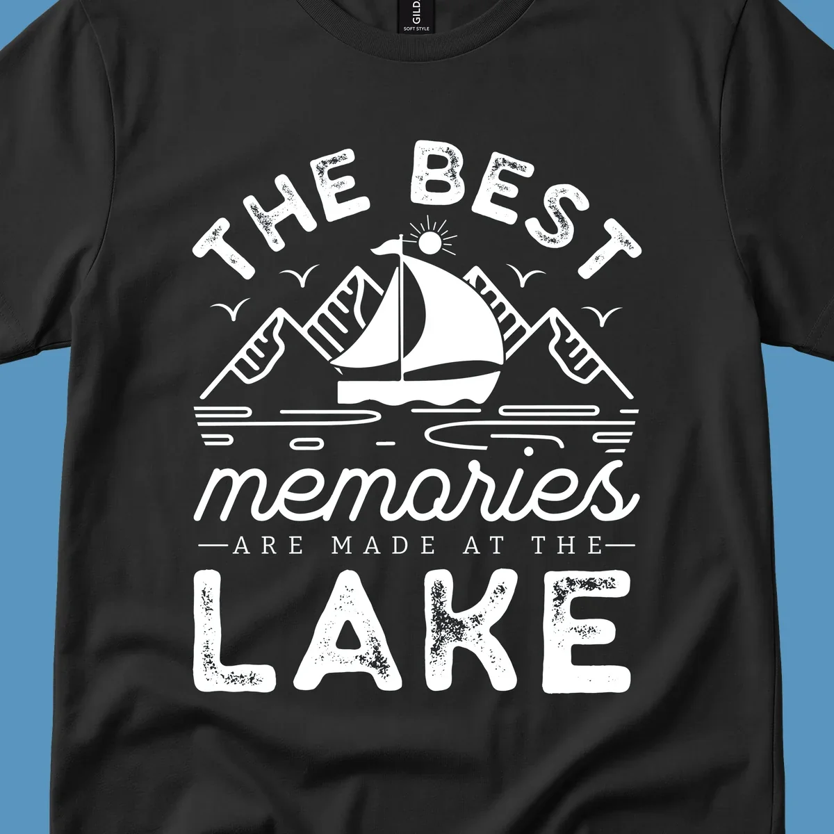 The Best Memories Are Made At The Lake design with mountains, sailboat, and text.