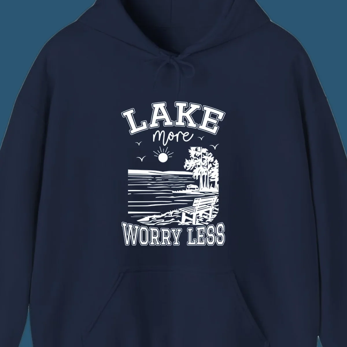 Lake More Worry Less scenic illustration with lake, trees, bench, and sun, white text on black, navy text on white.