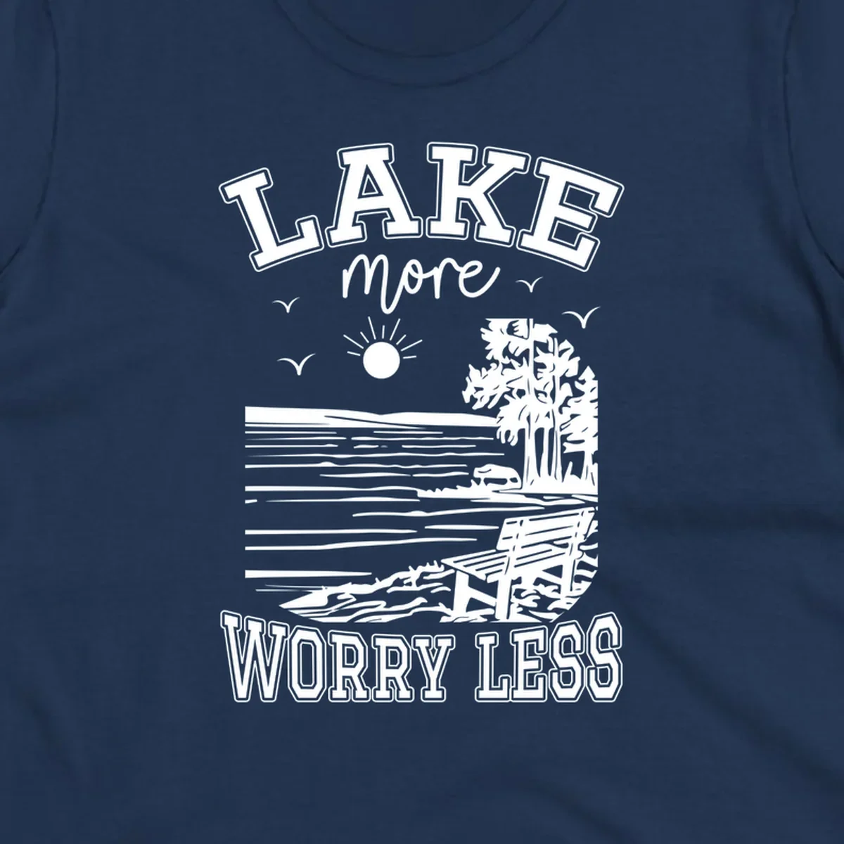 Lake More Worry Less scenic illustration with lake, trees, bench, and sun, white text on black, navy text on white.