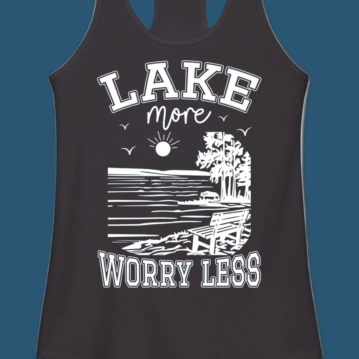 Lake More Worry Less scenic illustration with lake, trees, bench, and sun, white text on black, navy text on white.