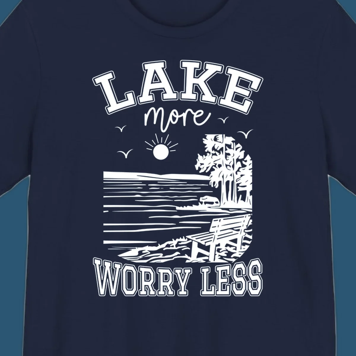 Lake More Worry Less scenic illustration with lake, trees, bench, and sun, white text on black, navy text on white.
